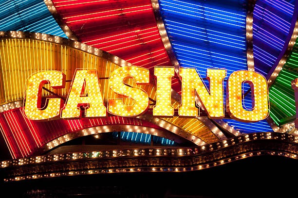 Live casino dealer operating a roulette wheel in a professional multi-camera studio